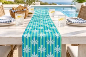 Balmy Palm table runner on a sunny poolside table with iced water, bread and striped napkins