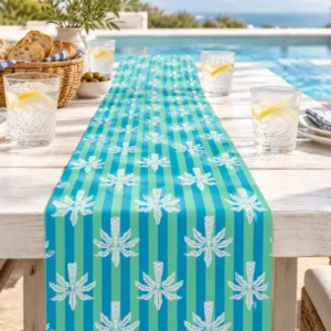 Balmy Palm table runner on a sunny poolside table with iced water, bread and striped napkins