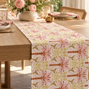 Blush Palm table runner on a light oak dining table with pink napkins and a vase of pink roses