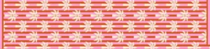 Candy Palm table runner laid flat showing cream palms on coral-red and white stripes with a pink border