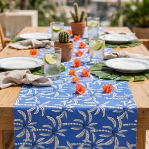Lagoon table runner on a wooden table on a palm-lined terrace