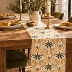 Sprightly Leopard table runner on a wooden dining table with olive-green velvet chairs, brass candlesticks and an olive branch jug