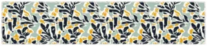 Sweeping table runner laid flat showing navy and mustard leaf shapes on pale sage