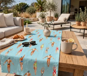 Swimmers table runner on a wooden coffee table on a sunny patio with croissants and sunglasses